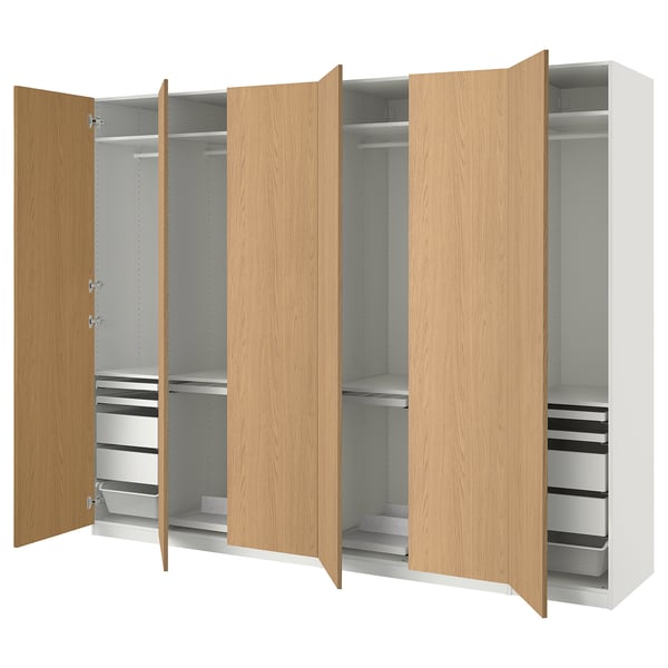 PAX wardrobe: light wood, modern design, open doors showing shelves, drawers, and compartments.