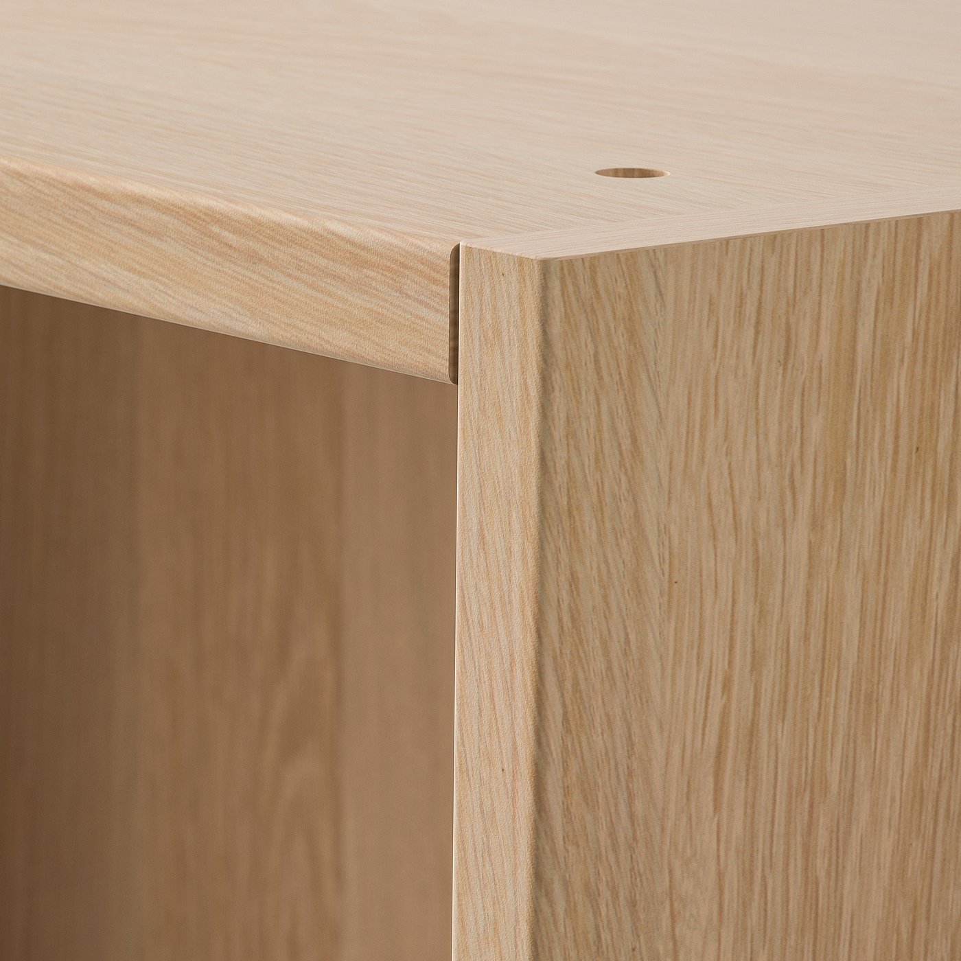 Close-up of PAX wardrobe corner, showcasing smooth, light wood grain texture and seamless craftsmanship.