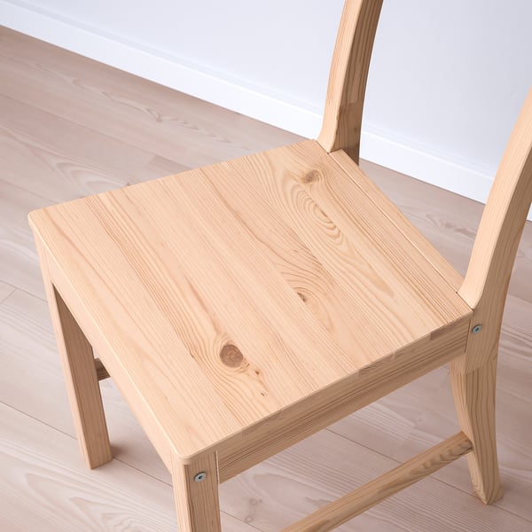 Natural wooden table and chair set in minimalist room. Light, smooth, and sturdy pine design.