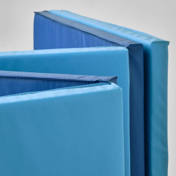 Foldable gym mats stacked neatly, showcasing soft padding and durable material. Ideal for acrobatics and safe landings.