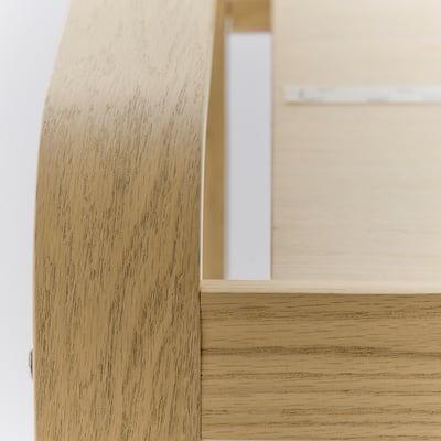 Close-up view of light wooden furniture showcasing smooth, well-crafted surface with natural grain.
