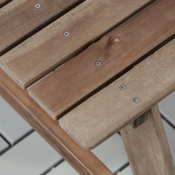 Wooden childrens picnic table with visible screws, sturdy and well-constructed.