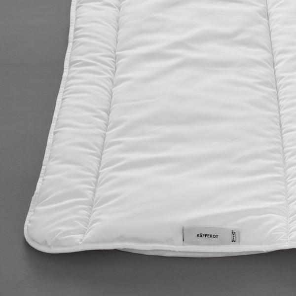 A close-up of a neatly folded, soft ikea SÄFFEROT duvet, showing its quilted pattern.