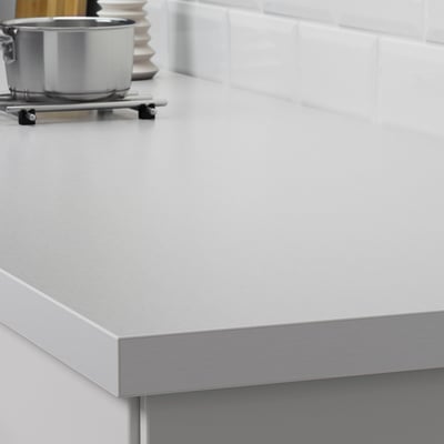 Modern kitchen countertop, easy to clean, resistant to spills and grease, with sleek metal edge.