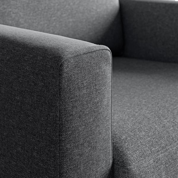 Modern fabric armchair close-up, showcasing high-quality, soft, textured upholstery and robust construction.