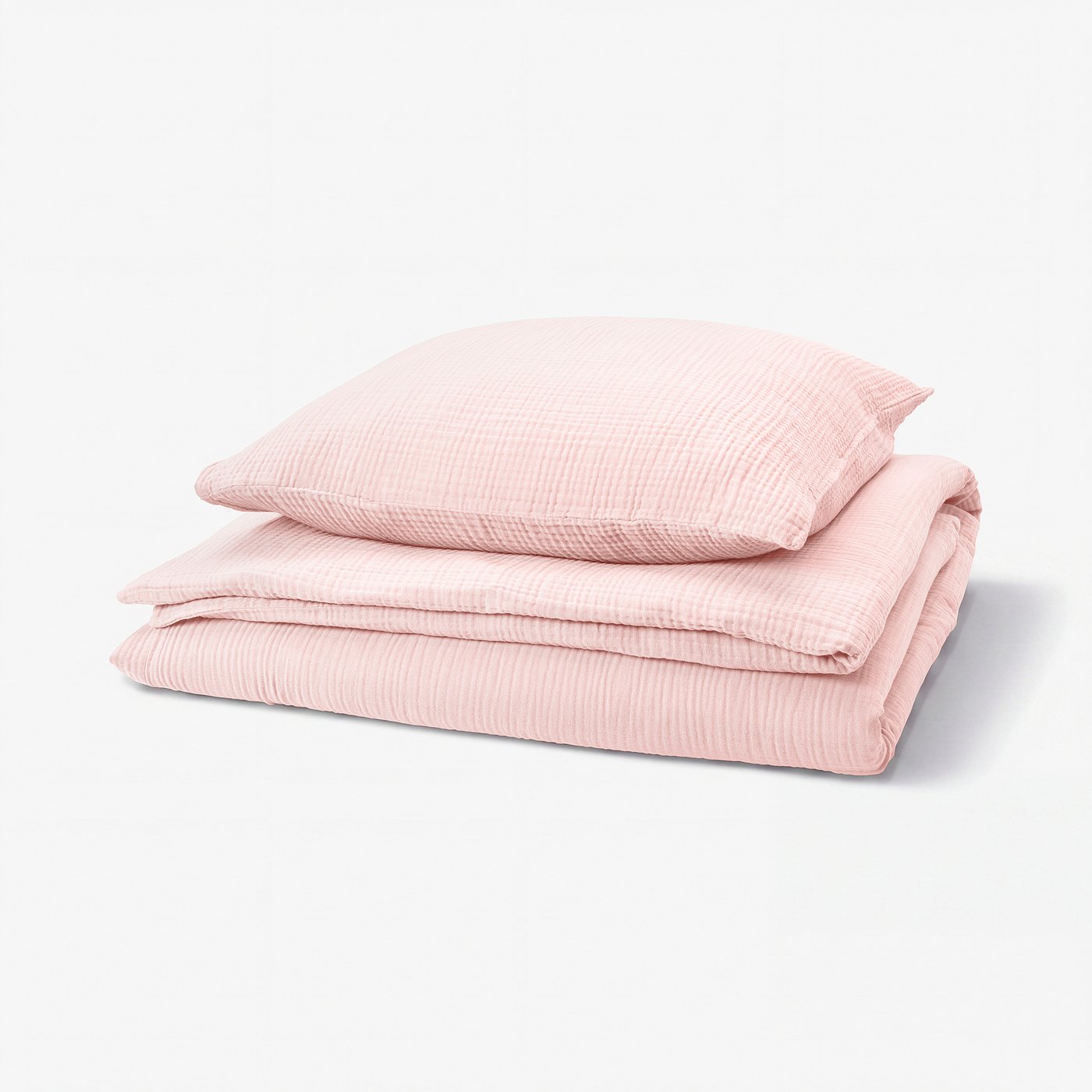 Pale pink bedding set, featuring fitted sheet, flat sheet, and pillowcases, crafted from soft, breathable muslin organic cotton with wavy texture.