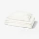 White SCHERSMIN organic cotton bedding set, featuring a duvet cover and pillowcase with wavy muslin texture for softness and breathability.