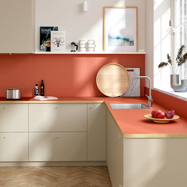 Modern kitchen with SIBBARP rust panels, sink, counters, apples.