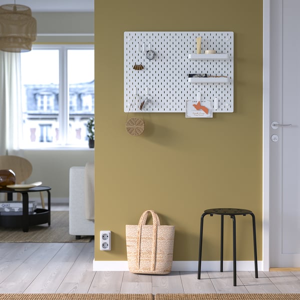 SKÅDIS pegboard, white, with accessories on green wall.