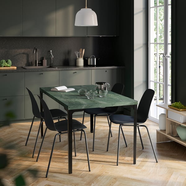 SKÅLSTA green table with black chairs in modern kitchen, near window.