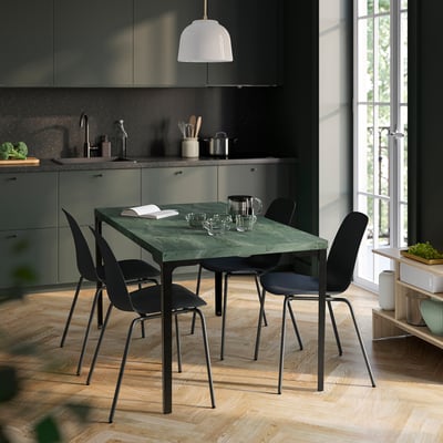 SKÅLSTA green table with black chairs in modern kitchen, near window.