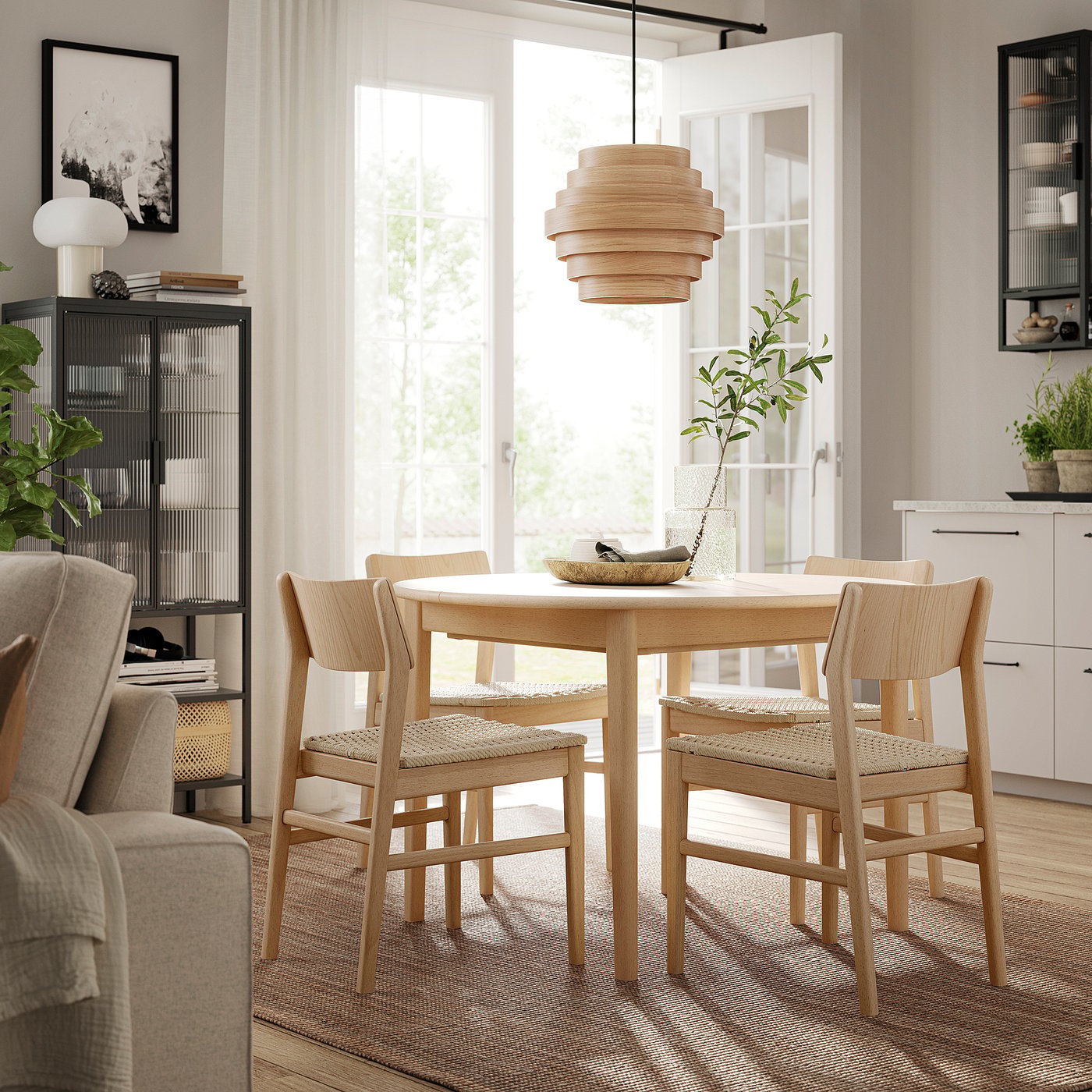 Modern dining room with SKANSNÄS wooden table and chairs, light wood, round shape, scandinavian design, hanging light, plants, shelves.