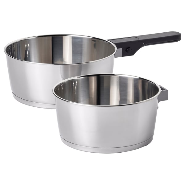 Two stainless steel SLÄTROCKA saucepans with removable black handles, stacked for storage.