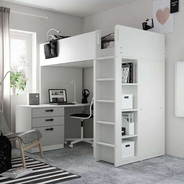 Modern kids room with white loft bed, desk, and storage. Black-and-white decor, striped rug, and cosy layout.