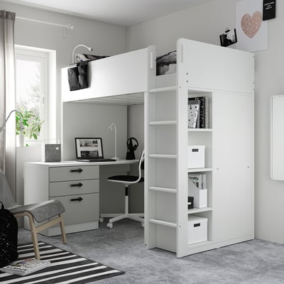 Modern kids room with white loft bed, desk, and storage. Black-and-white decor, striped rug, and cosy layout.