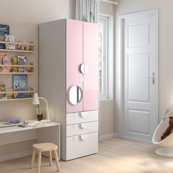 Kids room with pink-white wardrobe, bookshelves, desk, lamp, and teddy bear swing.