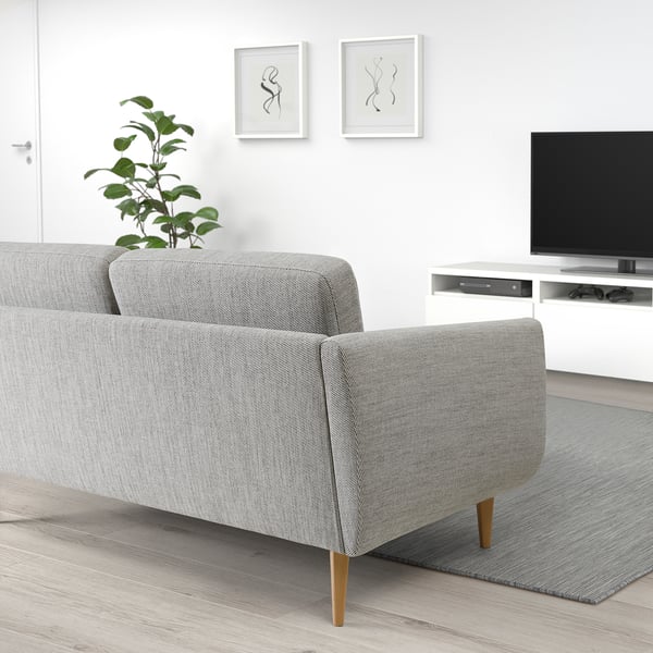 Modern living room with grey SMEDSTORP sofa, wooden legs, armrests, and cushions,tv on white stand, green plant, abstract wall art.