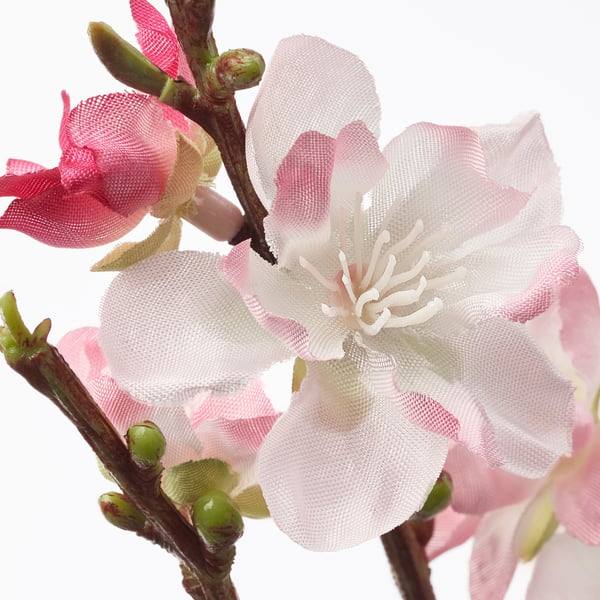 Lifelike artificial flowers in pink and white hues. Delicate mesh petals surround a central white stamen, mimicking real blossoms.