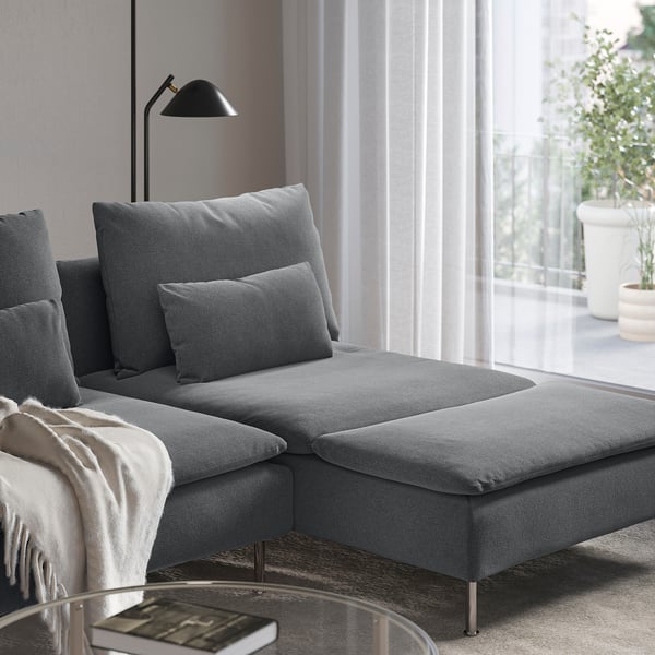Modern grey sofa with extendable chaise, plush cushions, and sleek metal legs, perfect for lounging.