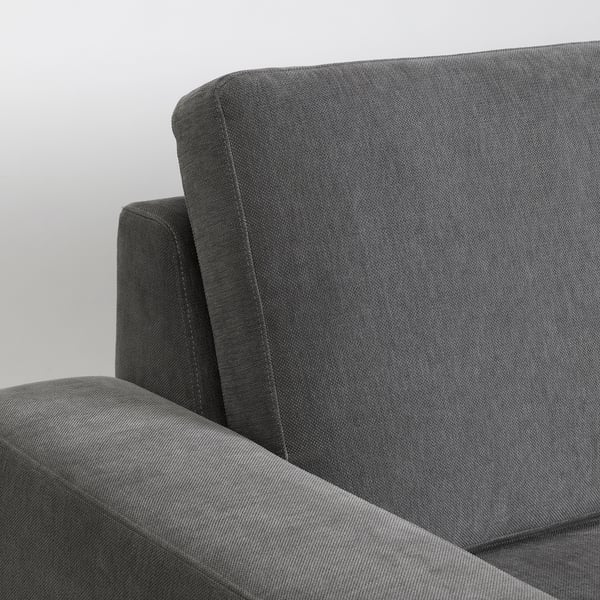 Close-up of modern grey sofas cushioned back and armrest, showcasing high-quality fabric and minimalist design.