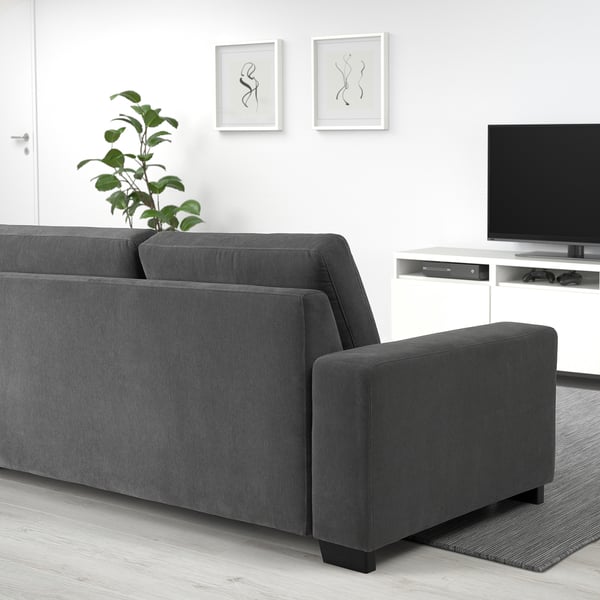 Modern living room with a grey SÖRVALLEN sofa, flat-screen tv, and small potted plant.