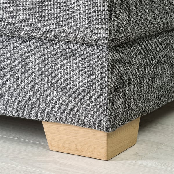 Close-up of a modern sofas corner, showcasing its durable, textured fabric and sturdy wooden leg.