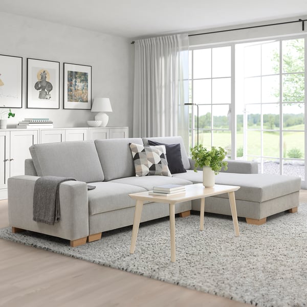 Modern SÖRVALLEN sectional sofa with cushions and coffee table, in bright living room.