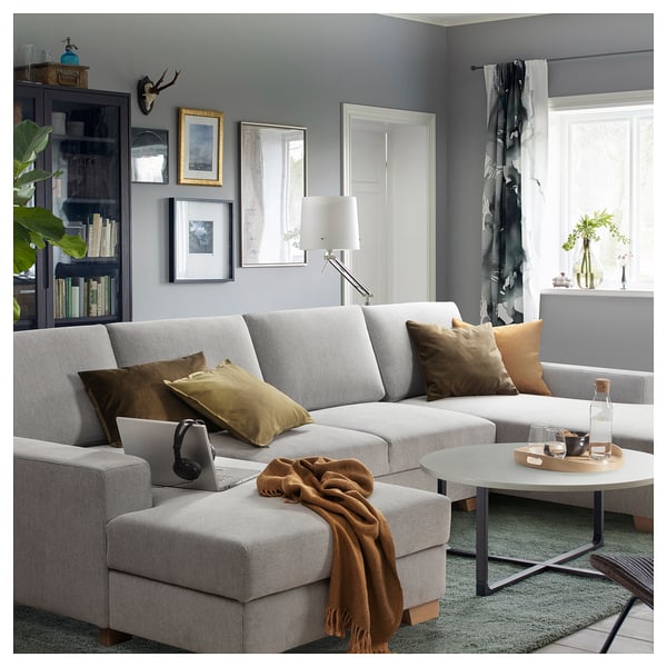 Modern living room with SÖRVALLEN sectional, colourful pillows, and large window.