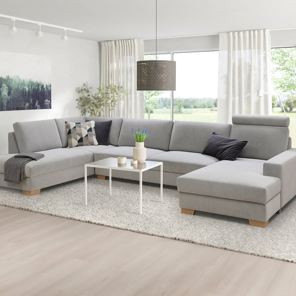 Minimalist SÖRVALLEN grey sofa set with chaise, white decor in bright room.
