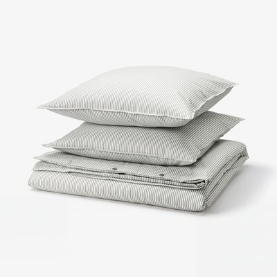 Stack of grey and white striped cotton bed linen, including duvet cover and pillows, neatly folded.