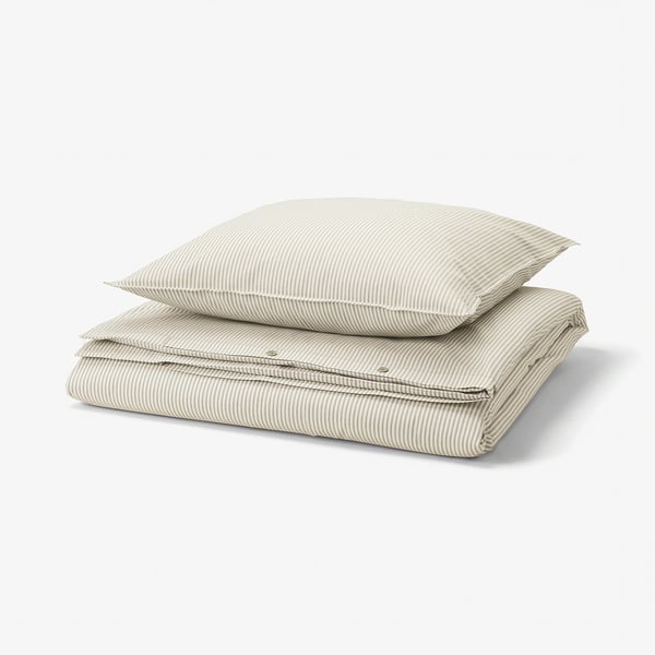 Stacked bedding set: beige and white striped duvet and pillow, cotton.