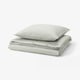 A SOLFIBBLA duvet set with green and white stripes, made of 100% cotton, neatly folded, square shape.