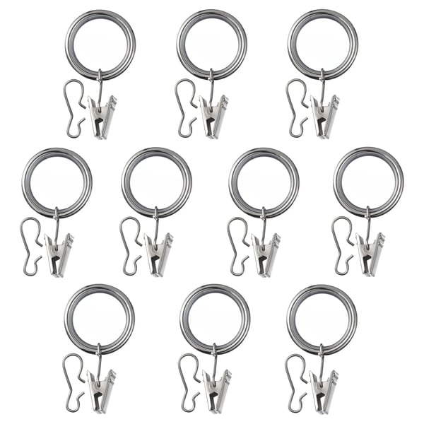 Image displays multiple chrome SYRLIG curtain ring sets with hooks and clips, arranged in rows.