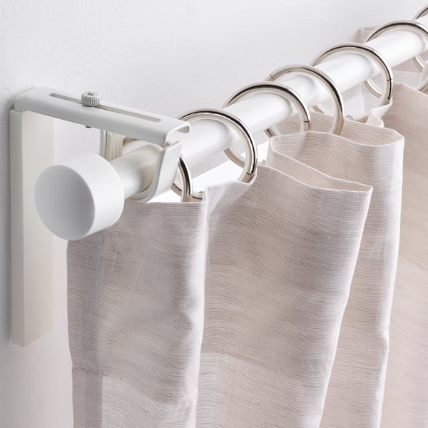 Light curtains hang on metal rod with multiple rings, clips, and hooks for easy sliding.
