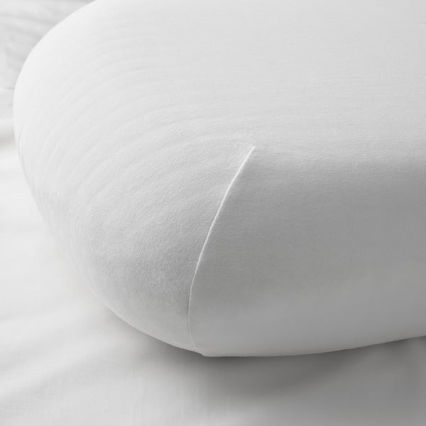 A close-up of a soft, white TÖCKENFLY pillowcase, showing fine cotton texture and elastic edge design.