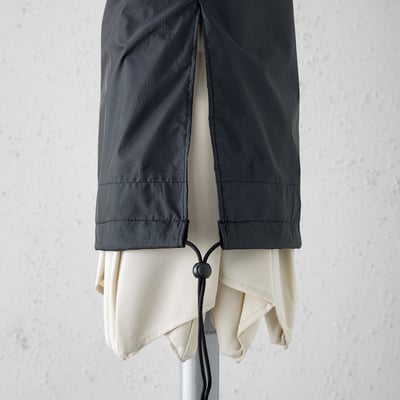 Waterproof parasol cover with drawstring, shown protecting a folded parasol.