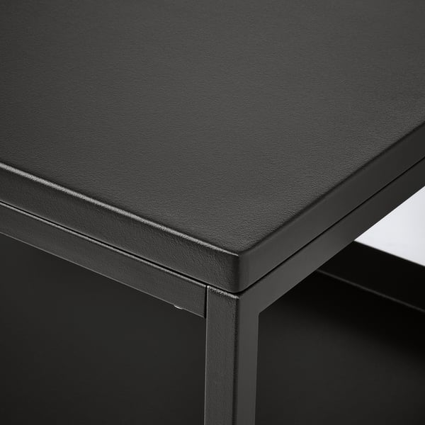 Black powder-coated metal table with sleek, rounded edges and a smooth surface, showcasing high-quality craftsmanship.