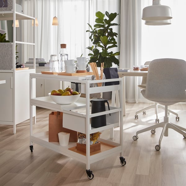 TROTTEN trolley near desk with fruit bowl, bottles, cups, plant.