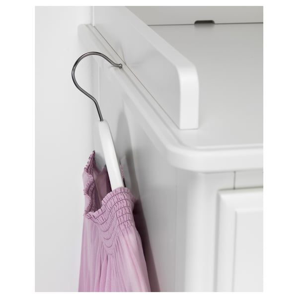 White hanging rail, metal hook, hangs light purple ruffled garment. Clean, modern setting.