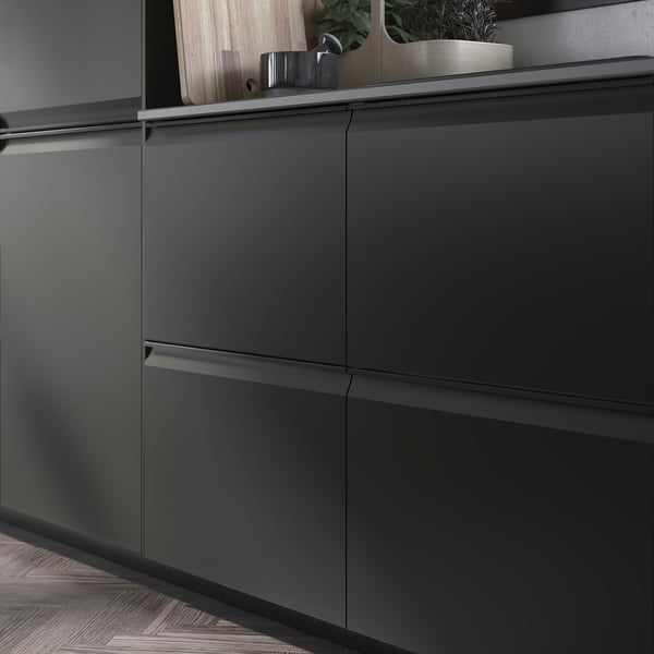Modern black kitchen cabinets with sleek, integrated handles and a matte finish.
