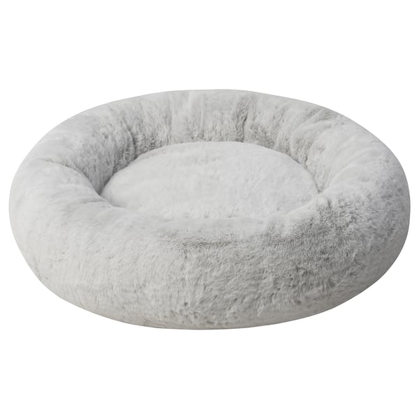 A soft, round pet bed named UTSÅDD in light grey colour. Made from recycled polyester, it raised edges for comfort. Ideal for medium-sized pets.