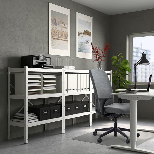 Home office with VALLFJÄLLET chair, desk, & storage. Chair tucked under, storage tall with shelves & decor.