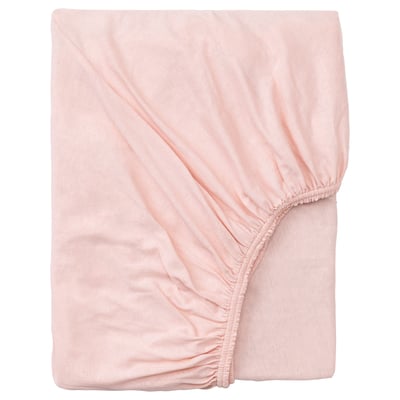 A peach-colored, soft cotton fitted bed sheet, neatly folded, with elastic edging for a secure fit.