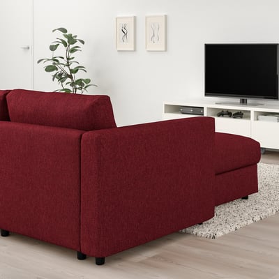 Red VIMLE modular sofa in living room with tv, gaming consoles, and rug.