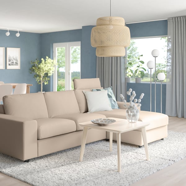 Modern living room: beige VIMLE sofa with light wood coffee table, large window, blue walls.