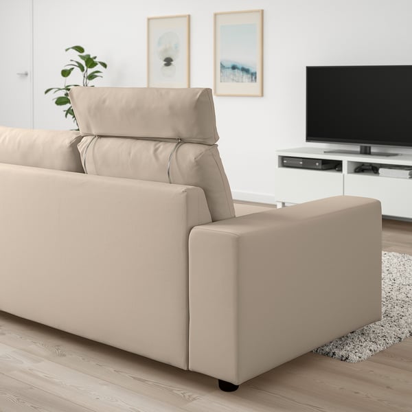 Modern beige VIMLE sofa in minimalist living room. Soft cushions, wide armrests, near flat-screen tv.