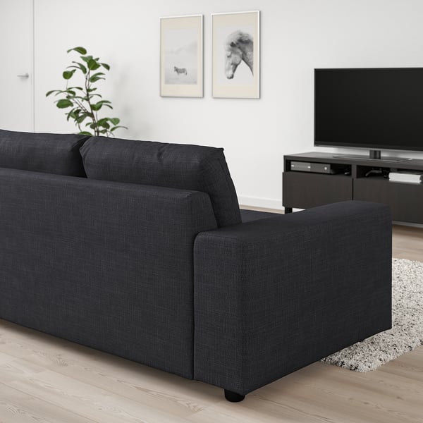 Modern living room with VIMLE charcoal sofa, flat screen tv, and plant.
