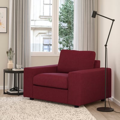 Bright red VIMLE accent armchair near large window, tall black floor lamp, cosy home setting.