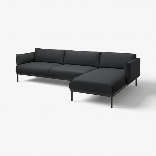 Moderne kulgrå L-formet sofa, slanke ben, blødt betræk, minimalistisk design.