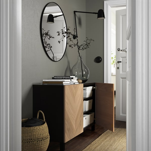 Moderne entré med skab, bøger, vase, spejl, lys